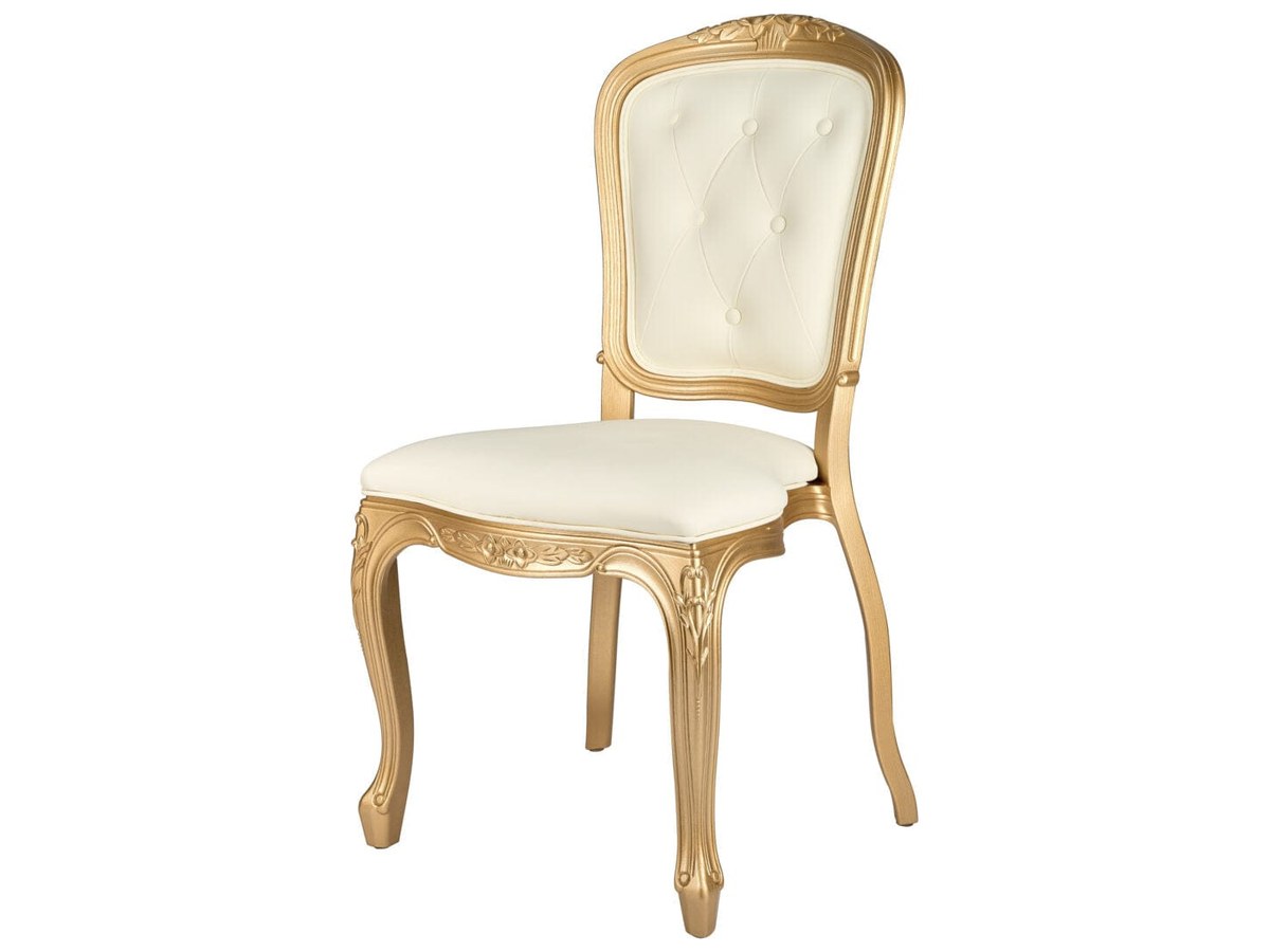 The carved frame and tufted back on the gold Chambeau colorway — the detail that puts this chair in the accent category, on a frame rated at 3,900 lbs.