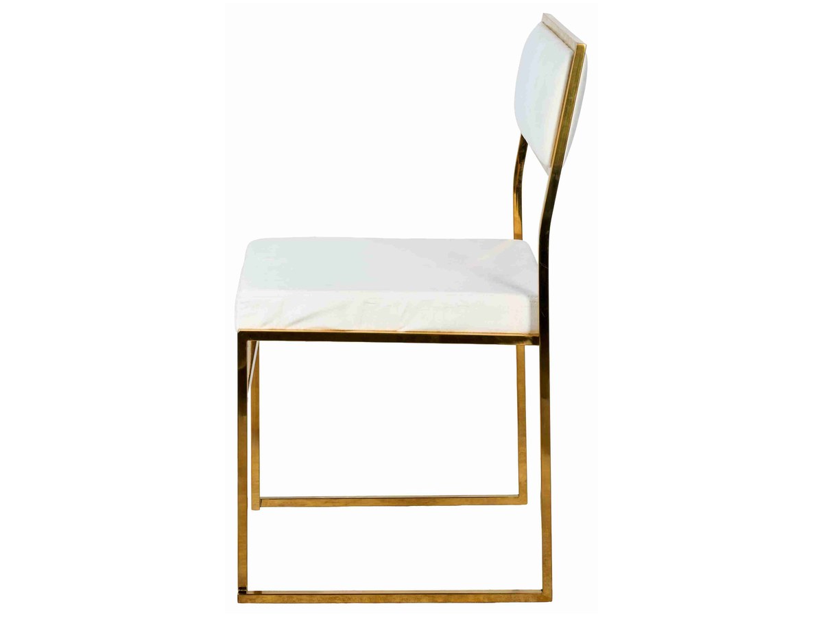 The white cushion on gold stainless. The cushions sit inside the frame with no visible fastener — the reason the chair photographs as two floating planes.