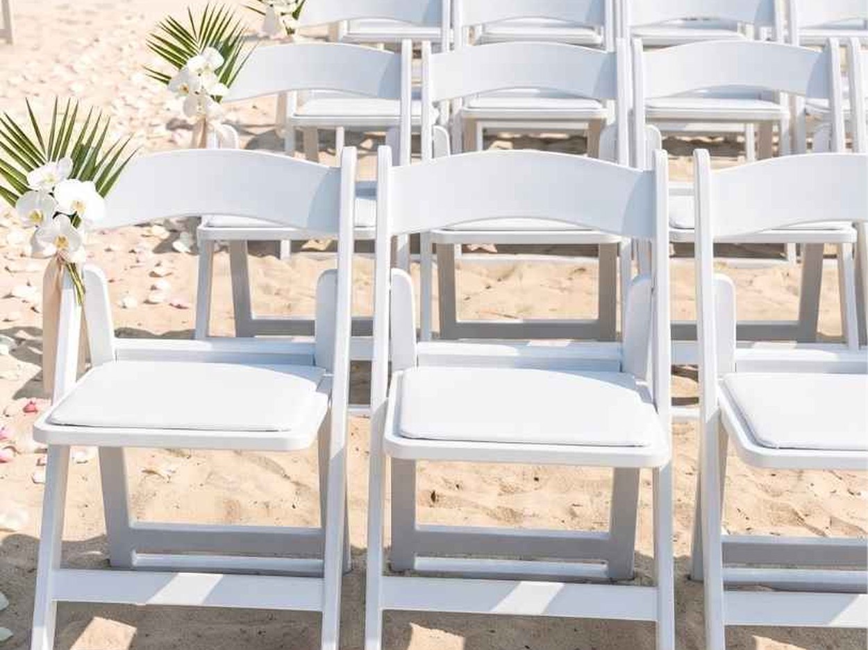 On sand — the setting the series is named for, and the one where an ordinary folding chair simply disappears into the ground.