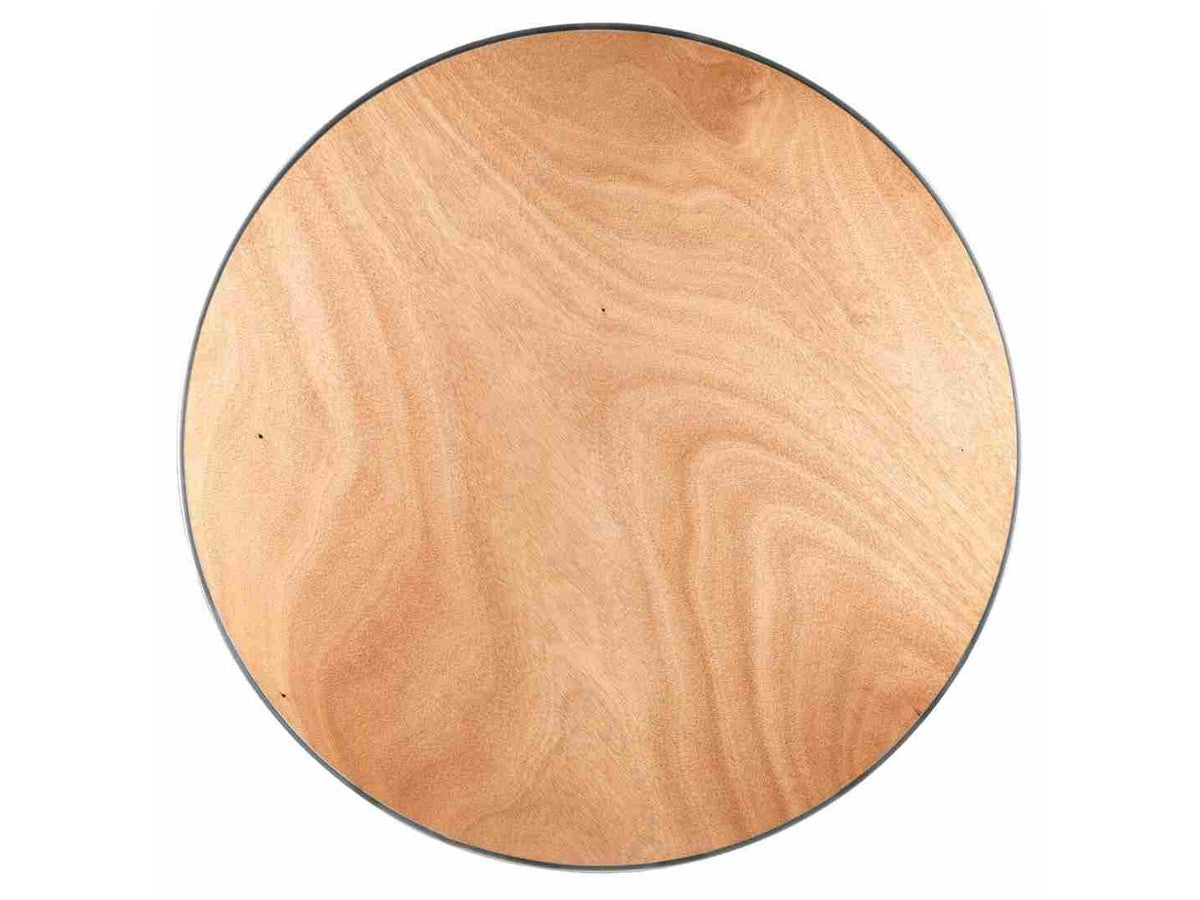 The plywood top with its metal C-channel edge. A structural surface — this table expects a linen.